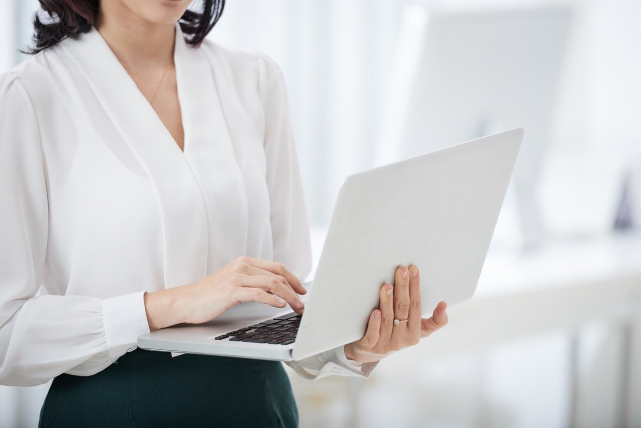 crop-businesswoman-using-laptop